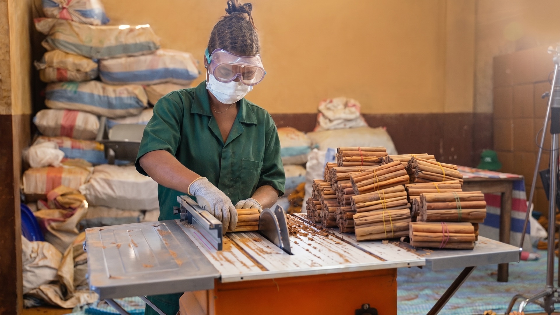 YAI team member preparing cinnamon bundles for Madagascar export
